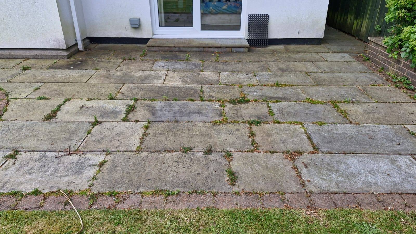 Softwashing a patio beside the lawn - Frosty Enterprises Ltd t/a Frostys Cleaning Services