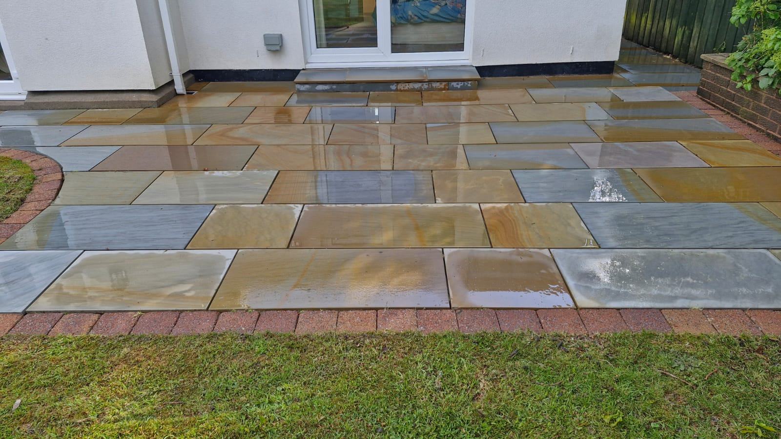 Softwashing a patio beside the lawn - Frosty Enterprises Ltd t/a Frostys Cleaning Services